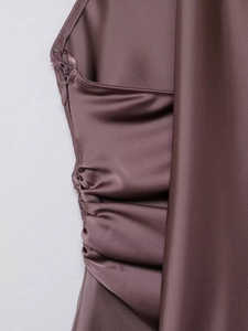 Macro shot of dark purple satin top with side invisible zipper and ruched details