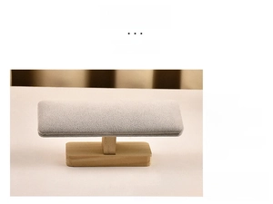 Detailed view of handmade solid wood jewelry display stand with light gray velvet surface