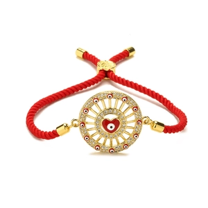 Red braided evil eye bracelet with golden heart pendant and sparkling crystals