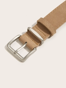 Detailed close-up of retro camel suede leather belt with matte silver square buckle