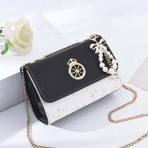 Women's black and white crossbody chain bag with star studs and pearl bow charm