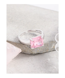 Macro shot of rectangular pink zircon stone on a silver minimalist open ring