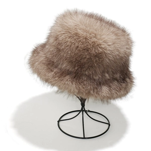 Detailed close-up of fluffy faux fox fur winter bucket hat on a metal wire stand