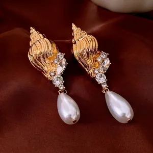 Vintage conch shell earrings with rhinestones and white drop pearls in golden finish