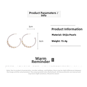 Detail of C-shaped earrings featuring Swarovski pearls and gold beads with 6cm diameter