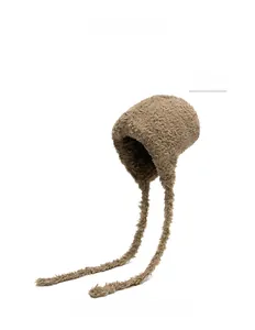 Detailed view of plush khaki winter hat with long ties and soft faux fur texture