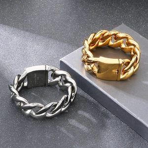 Detailed macro of gold and silver 316L stainless steel Cuban link bracelets on stones