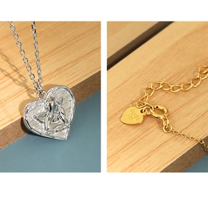 Macro detail of S925 sterling silver heart pendant and lobster clasp connector