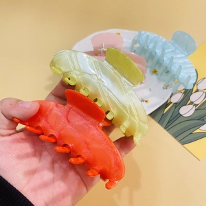 Sparkly acrylic shell shark hair clips in orange, pink, blue and green colors