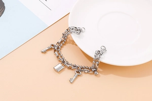 Double-layer stainless steel bracelet featuring round beads with lock and key pendants