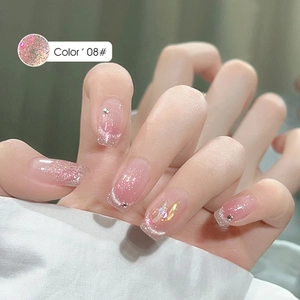 Detail of square-head pink gradient press-on nails with silver glitter and rhinestones