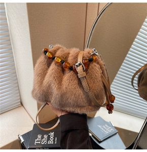 Close-up of faux rabbit fur bucket bag featuring amber acrylic beads and drawstring detail
