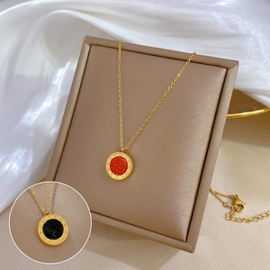 Close-up of gold titanium steel necklace with Roman numeral red and black pendants