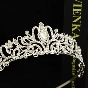 Detailed close-up of intricate silver bridal crown featuring sparkling pear-shaped crystals