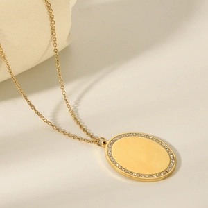 Polished 18k gold stainless steel oval pendant necklace with sparkling diamond border