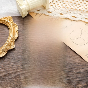 Detailed view of 18k gold knot necklaces on a friendship card with vintage background