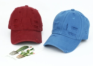 Close-up of distressed striped baseball caps in burgundy and blue with ripped details
