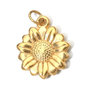 Macro detail of a golden sunflower charm pendant with intricate metallic texture and ring