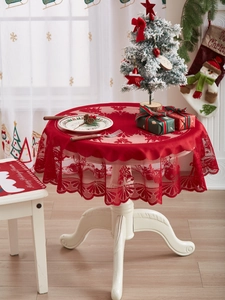 Detailed Christmas dining set with red lace tablecloth and matching chair cushions for holidays