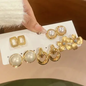 Detail view of vintage French style gold earring set with pearls and floral designs