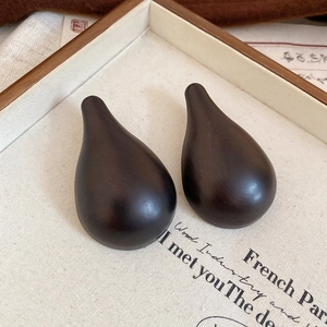 Close-up of smooth dark brown wood water-drop pendant earrings for women's vintage jewelry set