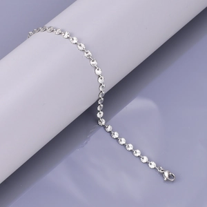 Macro shot of silver textured circular links and lobster clasp on a stylish bracelet