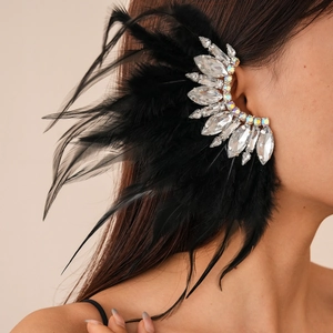 Detailed close-up of a black feather ear cuff with sparkling crystal rhinestones