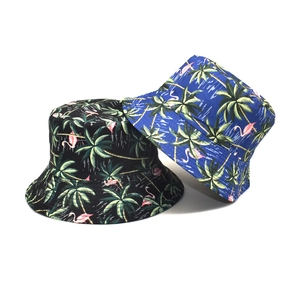 Tropical bucket hat featuring palm tree and flamingo prints in black and blue colors