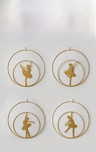 Detail of four golden metal ballet dancer silhouettes in circular frames for wall art