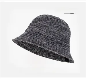 Close-up of light gray breathable knit bucket hat with textured weave and wavy brim