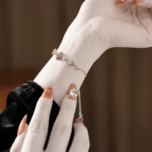 Silver plated clover bracelet featuring pavé zircon flowers and adjustable box chain