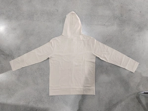 Flat lay back view of a beige linen hooded shirt with raglan sleeves and ribbed cuffs