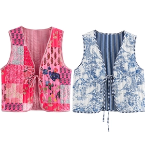 Close-up of quilted floral vests with tie-front ribbons and detailed stitching