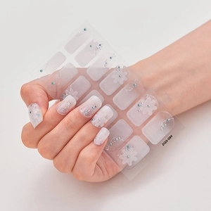 Laser 3D nail art stickers with white floral patterns and blue rhinestones for manicures