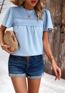 Detail of blue chiffon blouse showing dot texture and intricate lace embroidery