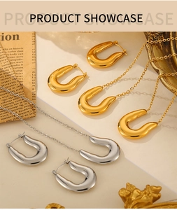 Flat lay of U-shaped stainless steel jewelry sets with gold and silver horseshoe pendants