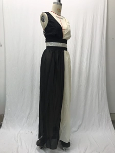 Detail of minimalist black and white sleeveless dress with contrast stitching and waist belt
