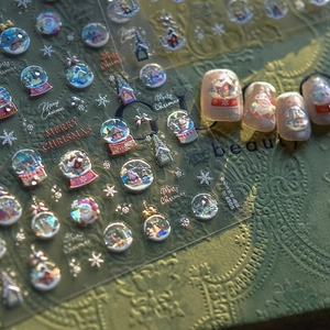Macro detail of 3D embossed Christmas nail stickers with snowflake and Santa Claus patterns