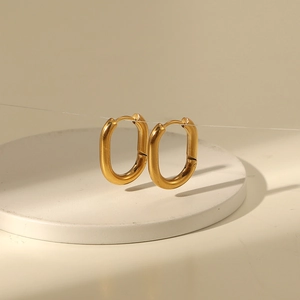 Polished 14K gold-plated oval U-shaped earrings displayed on a white minimal stand
