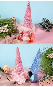 Detail of sequins on handmade wedding gnomes with lace skirts and braided hats