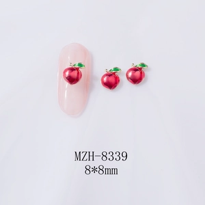 Macro shot of 8x8mm peach-shaped alloy nail charms with vibrant red and green enamel finish