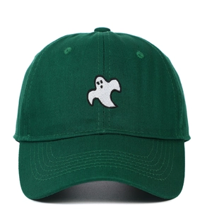 Close-up of white ghost embroidery on a dark green cotton twill baseball cap
