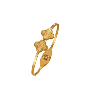 Adjustable gold titanium steel clover bangle featuring a radiant textured petal design