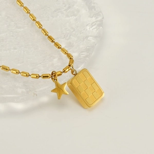 Collier en acier doré avec pendentifs étoile et damier sur assiette en verre