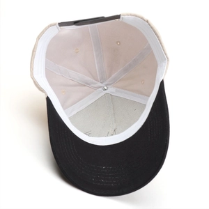 Detailed interior view of a color-block baseball cap showing stitch lines and back strap
