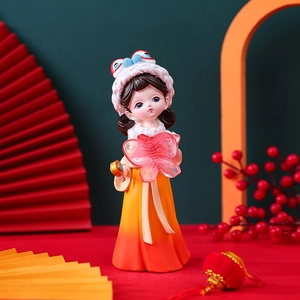 Detail of Hanfu girl figurine with orange dress and pink butterfly decoration