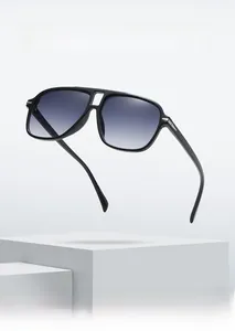 Detail of pilot sunglasses with double bridge and blue-grey gradient lenses on white stone