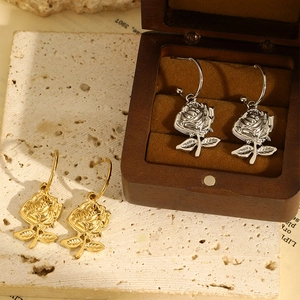 Elegant rose gold and silver stainless steel earrings with realistic flower and leaf pendants