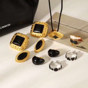 Flat lay of vintage gold and enamel jewelry set featuring earrings, rings and necklace