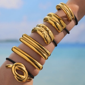 Minimalist gold metal geometric hair ties with high elasticity bands on beach background